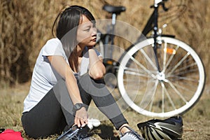 Portrait woman on biking journey drinking water from bottle