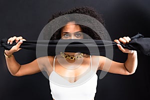 Portrait of a woman with a black cloth over her face in protest against machismo photo