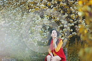 Portrait of a woman in blooming trees. Spring season specific. Dreamy. Blossom. Happy