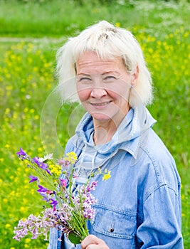 Portrait of woman with a bouquet of wild flowers