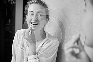 Portrait of woman with braces demonstrating interdental brushing