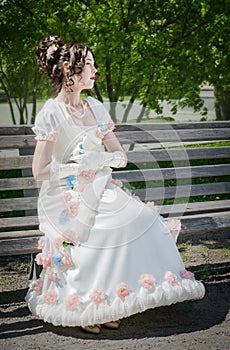 Portrait of woman in bride dress with a book in their hands.