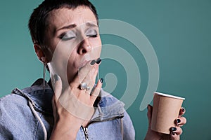 Portrait of woman burned her tongue after tasting too hot coffee during work break time