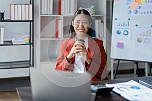 Portrait of a woman business owner showing a happy smiling face as he has successfully invested her business using