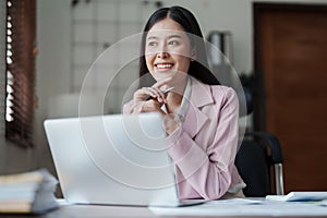 Portrait of a woman business owner showing a happy smiling face as he has successfully invested her business using