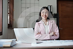 Portrait of a woman business owner showing a happy smiling face as he has successfully invested her business using