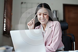 Portrait of a woman business owner showing a happy smiling face as he has successfully invested her business using