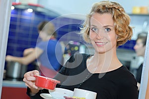 Portrait woman carrying ramekin dish