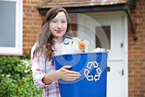 Portrait Of Woman Carrying Recycling Bin