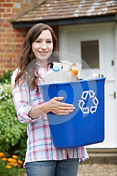 Portrait Of Woman Carrying Recycling Bin