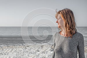 Portrait of a woman with clair eyes and marine background, contrast grey