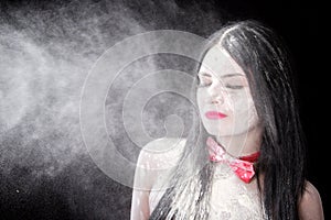 Portrait of a woman in a cloud of white powder