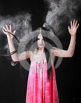 Portrait of a woman in a cloud of white powder
