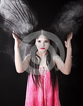 Portrait of a woman in a cloud of white powder