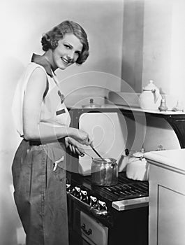 Portrait of woman cooking at stove