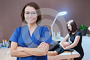 Portrait of woman cosmetologist doctor with crossed arms at beauty clinic