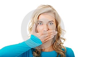 Portrait of a woman covering her mouth