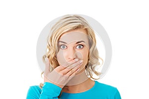 Portrait of a woman covering her mouth