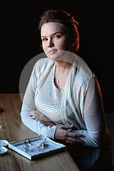 Portrait of woman, creating wedding jewelry, workplace of decorator. Woman`s hands in a process of creation