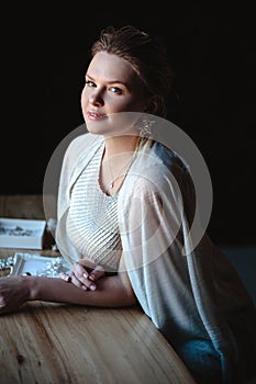 Portrait of woman, creating wedding jewelry, workplace of decorator. Woman`s hands in a process of creation