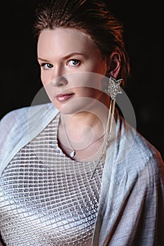 Portrait of woman, creating wedding jewelry, workplace of decorator. Woman`s hands in a process of creation