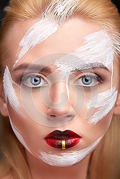 Portrait of woman with creative makeup white paint