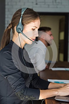 Portrait of woman customer service worker, call center smiling operator with phone on office