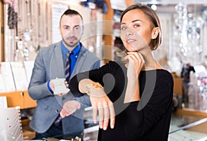 Portrait of woman customer trying bracelet