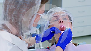 Portrait of woman on dentist preventive examination in stomatology clinic.