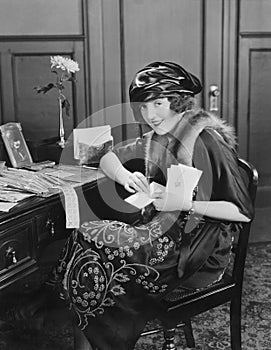 Portrait of woman at desk with letters