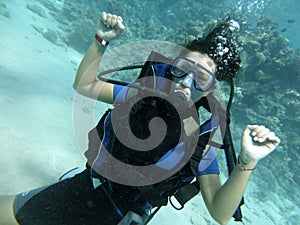 Portrait of a woman diving under water