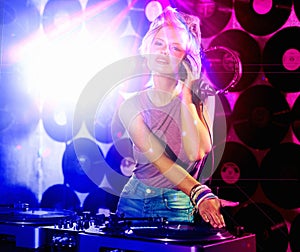 Portrait, woman dj and headphones for retro, nightclub and party with neon lights and lens flare. Happy gen z person