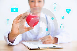 Portrait of woman doctor with holding red heart, Health care con photo