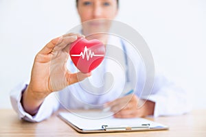 Portrait of woman doctor with holding red heart, Health care con