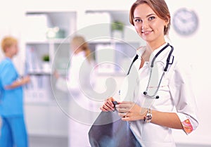 Portrait of woman doctor standing at hospital