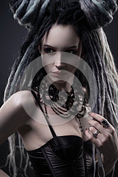 Portrait of woman with dreads and festive black gothic dress