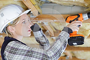 portrait woman drilling wood