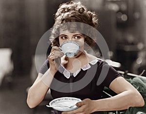 Portrait of woman drinking from teacup photo