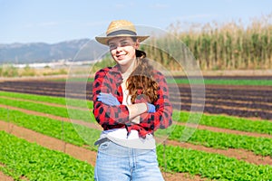 Portrait of woman farmer standing at the farm field