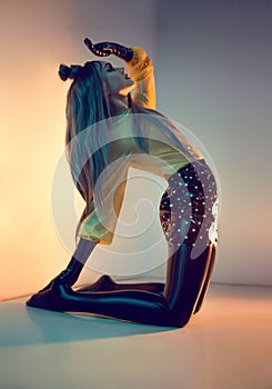 Portrait of woman in fashion latex clothes and long hair