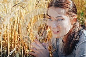 Portrait of woman on a field full of yellow ears