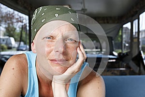 Portrait of a woman fighting breast cancer wearing a bandana.