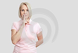 Portrait woman with finger on lips, or secret gesture hand sign