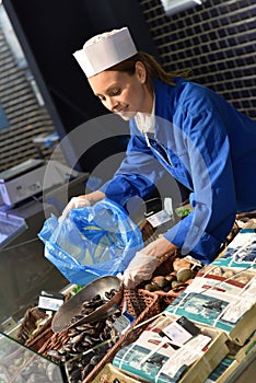 Portrait of woman fishmonger at work