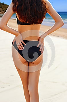 Portrait of woman flaunting her bottom in bikini photo