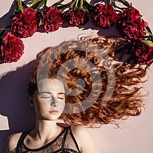 Portrait of woman with flowers, curly hair.