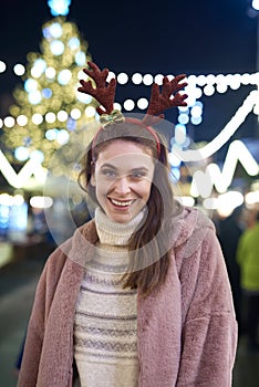 Portrait of woman in funny deer hairband