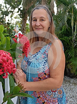 Portrait of woman in garden with flowers