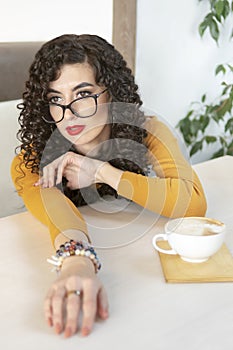 Portrait of woman with glasses in cafe