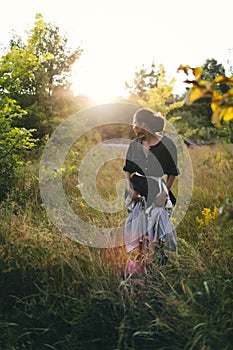 Portrait of woman in golden sunset light in outdoor meadow. Springtime and summer lifestyle. Wellbeing and zen like